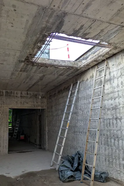Die Arbeiter haben das alte Gebäude entkernt: Jetzt fällt der Blick durch große Öffnungen in der Decke auf den Himmel. | Foto: fes