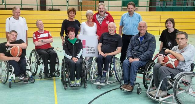 Gut lachen haben die „Rollis“ des TV Donrath mit ihrem Abteilungsleiter Alexander Muck (2.v.l.) und Trainer Uwe Kögler, Ute Clever und Gabriele Willscheid von der Stiftung, sowie dem TV-Vorsitzenden Achim Haas und Geschäftsführer Lars Faulenbach (stehend, v.l.). | Foto: BürgerStiftung Lohmar