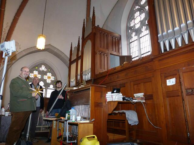 Musikdirektor Dirk van Betteray (l.) lässt sich von Orgelbauer Matthias Joanning (M.) und dem Auszubildenden Nicolai Wagner die Reinigung der Klais-Orgel in Holpe erläutern.                 | Foto: Christoph Buchen