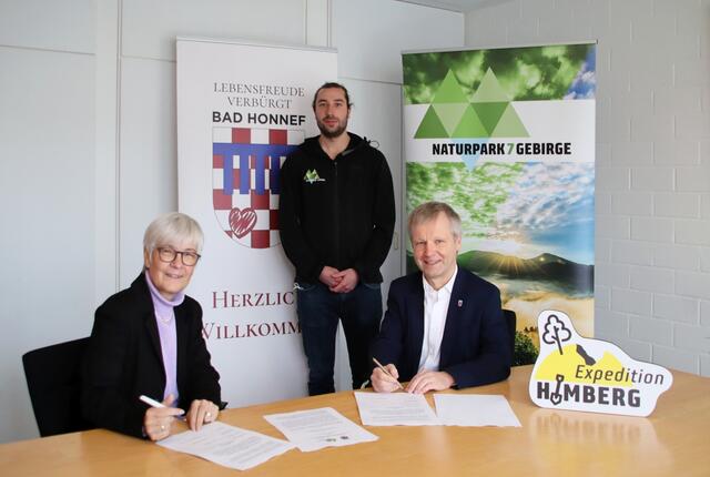 Brigitte Kohlhaas, Linus Steinbach (Rhein-Sieg-Kreis - organisatorische Betreuung Naturpark) und Bürgermeister Otto Neuhoff (re.) bei der Unterzeichnung des Vertrages zur Übergabe des Erlebnisweges Himberg an die Stadt.