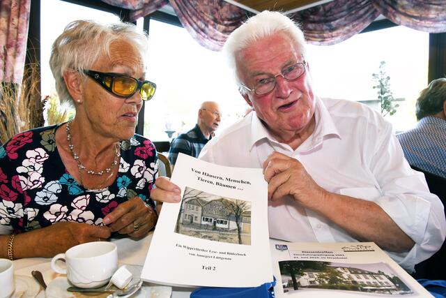 Wipperfürths ehemaliger Bürgermeister sowie Landrat des Oberbergischen Kreises, Hans-Leo Kausemann, erinnert sich gerne an die alte Schulzeit, hier mit der ehemaligen Klassenkameradin Anne Hell und einer Broschüre des Wipperfürther Heimatvreins. | Foto: Dierke