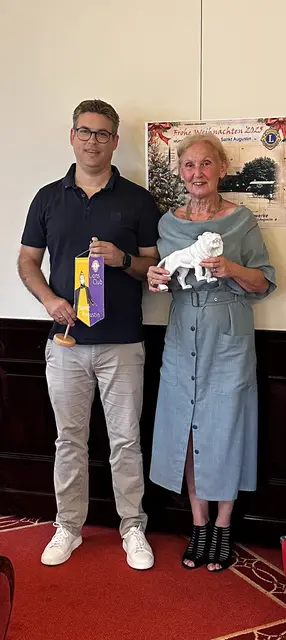 Birgitt Kreitz-Henn hält den markanten Löwen bedeutungsvoll fest in den Händen. Chris-tian Bieker zeigt mit Stolz den Wimpel des Sankt Augustiner Clubs mit dem Heiligen Au-gustinus als Schutzpatron.  | Foto: Foto: Lions Club