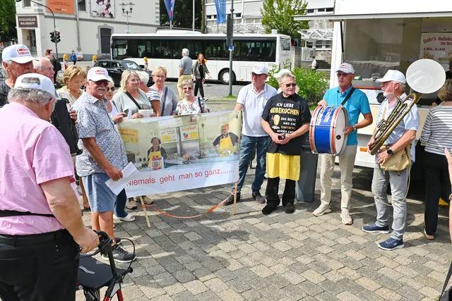 Zur Verabschiedung von „Dohr’s Reibekuchen“ waren viele Freunde von Bernd Dohr (3.v.re.) zum Eitorfer Wochenmarkt gekommen und sangen und spielten ihm und seiner Frau zu Ehren ein Ständchen. | Foto: Herkenrath