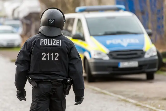 Ein Polizeibeamter auf dem Weg zum Streifenwagen. Symbolbild. | Foto: benjaminnolte - stock.adobe.com