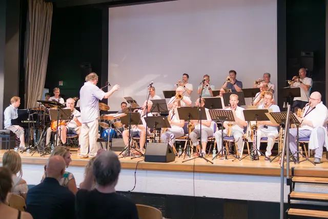 Klaus Steglich (re. hinter dem Dirigenten) am Saxophon hatte nach 25 Jahren fürs Jubiläumskonzert nochmal eine Big Band aus ehemaligen Schülern, Lehrern, aktiven Schülern zusammengetrommelt. Sein ehemaliger Kollege Matthias Ludewig gab den Takt an.  | Foto: Gianni Rasbach