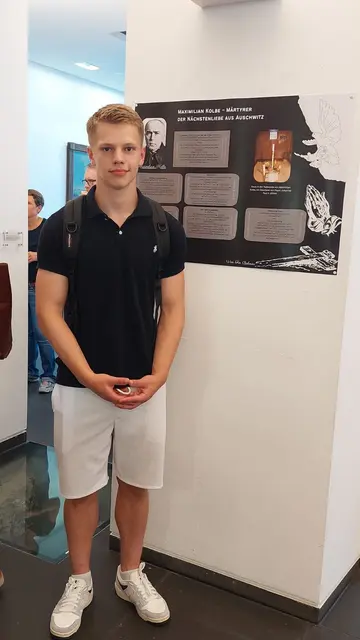 Fin Bohnau vor seinem Ausstellungsplakat. | Foto: Städtische Gesamtschule Am Michaelsberg